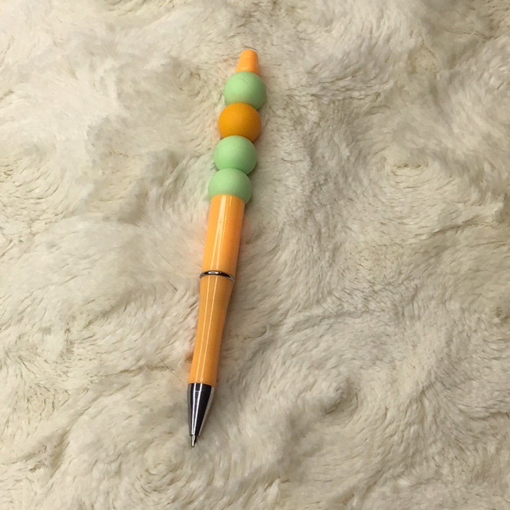 Handcrafted beaded pen. Peach/light green.  Made with bpa free silicone